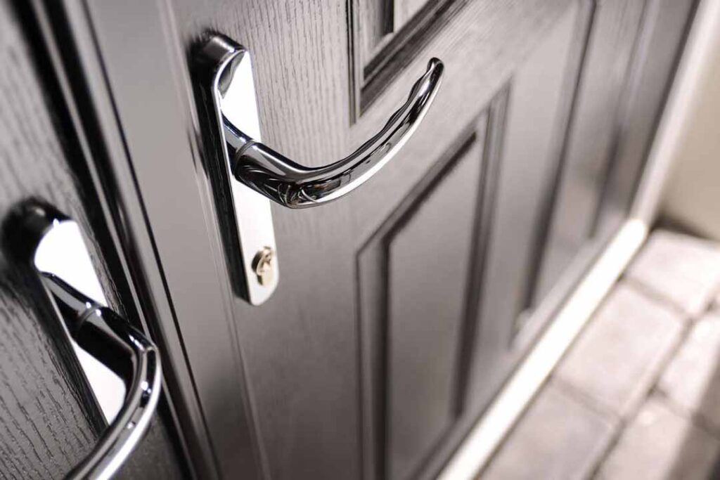 Composite door hardware in durable finishes, combining a secure handle, quality hinges, and refined detailing for long-term performance.