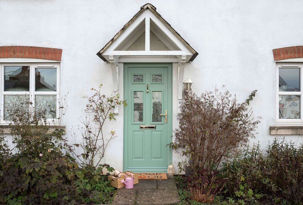 Traditional glazed composite door with classic proportions and decorative glass, allowing natural light while maintaining security and thermal performance.